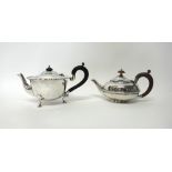 A silver teapot, having a shaped rim, raised on three hoof shaped feet,