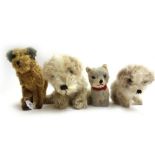 An Alpha Farnell musical toy dog, one similar smaller, and two straw filled toys, (4).