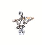 A diamond ring, in an Art Nouveau inspired scroll and foliate spray design,