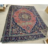 A Hamadan carpet, first half 20th century, with pink lozenge shaped field and blue medallion,