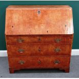 An 18th century Continental mahogany bureau with fitted interior, over three long graduated drawers,