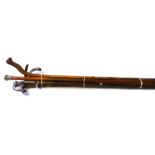 An early 20th century hazel walking stick, with a white metal handle, 83cm long,