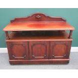 A Victorian mahogany buffet, with open tier over three panel cupboards, on plinth base,
