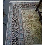 A large Indian carpet, the ivory field with central small medallion and foliate tendrils,