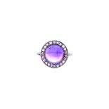 A cabochon amethyst and rose diamond set ring, mounted with the cabochon amethyst at the centre,