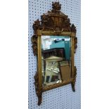 An 18th century Italian gilt framed wall mirror, with floral crest, 53cm wide x 100cm high,