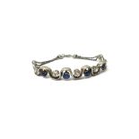 A platinum, sapphire and diamond bracelet, the curved front in an undulating design,