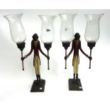 A pair of modern polychrome painted metal two branch candelabra, modelled as a suited monkey,