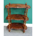 A Victorian marquetry inlaid figured walnut shaped three tier whatnot, on fluted supports,