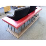 A gilt metal Victorian style club fender, modern, with red leather upholstery,