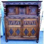 A 17th century and later oak court cupboard, with turned columns about various carved panel doors,