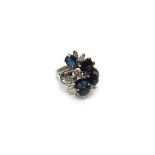 A white gold, sapphire and diamond ring, in an abstract design,