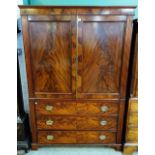 A Regency mahogany linen press, with a pair of panelled doors over three long drawers,