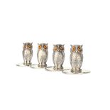 A set of four silver menu stands, each designed as a standing owl, having boot button eyes,