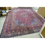 A Doroksh carpet with plum field and central medallion, light blue spandrels and banded border,