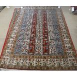 A Ghom rug, Persian, the field with columns of floral design, an ivory floral border, 138cm x 196cm.