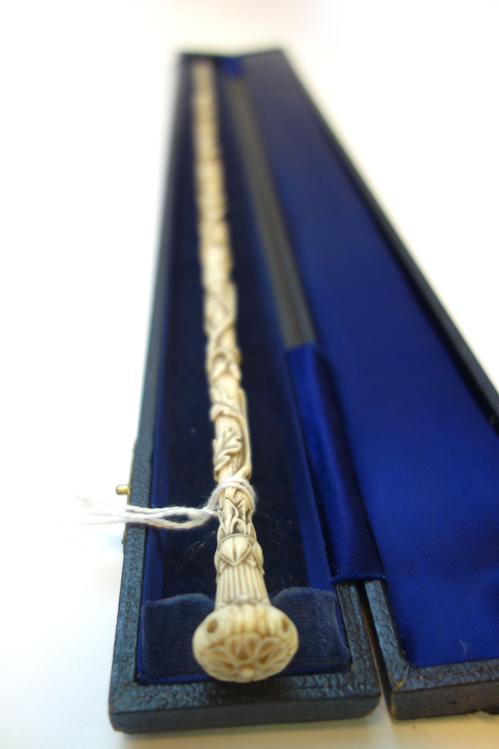 An ivory conductors baton, 19th century, intricately carved all over with vines,