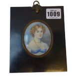 A mid-19th century English School portrait miniature on ivory of 'Miss Danby', her hair in ringlets,