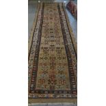 A North West Persian runner, the fawn field with rows of hooked motifs, single plants,