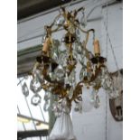 A French gilt metal and glass lustre four branch chandelier, 20th century, of open frame form,