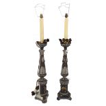 A pair of Italian painted and gilt pricket candlesticks, later adapted as lamp bases, 65cm high,