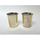 A pair of silver beakers, each of tapered cylindrical form,