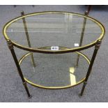 An early 20th century lacquered brass oval two tier etagere, on turned supports,