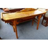 A 19th century Chinese elm altar table, with carved frieze on turned supports,