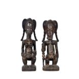 A pair of African carved wooden tribal figures, mid-20th century, both seated,