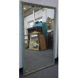 A large 19th century rectangular wall mirror with green painted faceted carved frame,