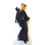 An unusual Swiss sailor doll, early/mid 20th century, with painted ceramic head and hands,