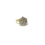 A gold and diamond set nineteen stone hexagonal cluster ring, claw set with circular cut diamonds,