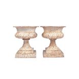 A pair of white painted cast iron jardinieres, each with semi lobed body and fluted socle,