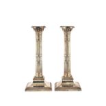 A pair of Victorian silver table candlesticks, each of classical column form,