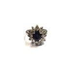 A gold and platinum, sapphire and diamond set flowerhead shaped cluster ring,