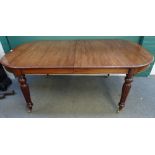 A Regency style mahogany extending dining table, on baluster reeded supports, with two extra leaves,