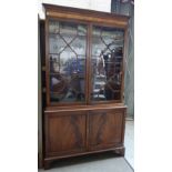 A George III mahogany and satinwood bookcase,