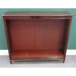 A mahogany floor standing open bookcase, on tapering square supports,