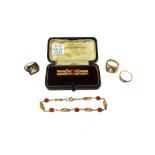 A gold and red gem set bar brooch, detailed 9 CT, with a case, a gold bracelet,