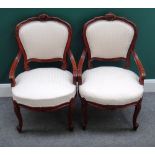 A pair of Louis XV style walnut framed open armchairs, each with bow seat and scroll supports,