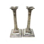 A pair of silver table candlesticks, each formed as a Classical column,