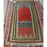 A Ladik prayer rug, the plain madder mehrab rising to a pale indigo arch, various minor borders,