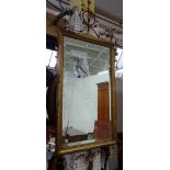 A 19th century gilt framed wall mirror with moulded floral chased crest over rectangular plate and