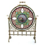 A Victorian brass and glass mounted fire screen of Gothic style,
