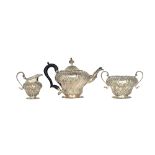 A late Victorian silver three piece tea set, comprising; a teapot,