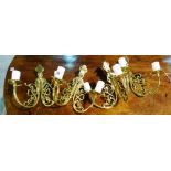 A set of four modern brass two branch wall lights of foliate scroll design, 30cm high, (4).