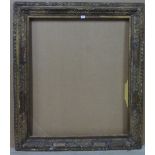 An 18th century style carved giltwood frame, with foliate decoration, the aperture 91.5cm x 76cm.