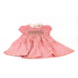 A Shirley Temple doll dress, by the Ideal Novelty and Toy Co USA, in red gingham with smocked front,