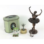 A small cast metal ballerina figure on o