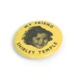 A vintage Shirley Temple badge, central